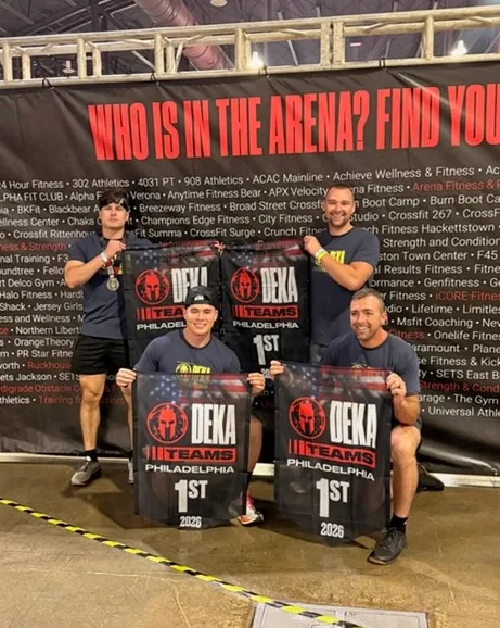 CrossFit Surge athletes with first-place DEKA team banners