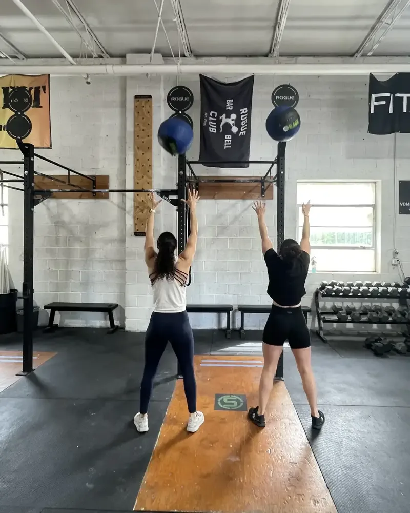 Two members throwing wall balls