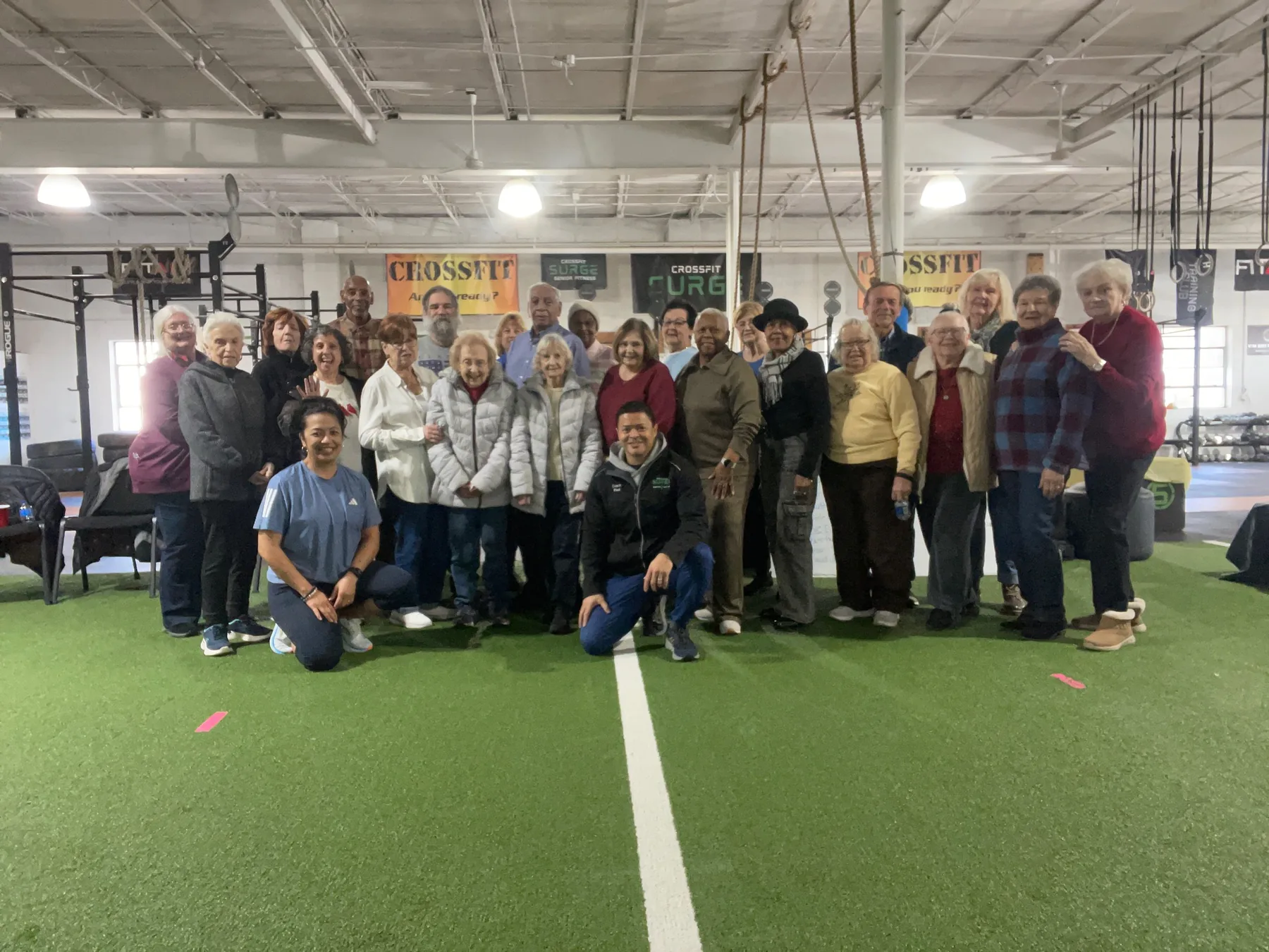 The Senior Fitness group together on the turf