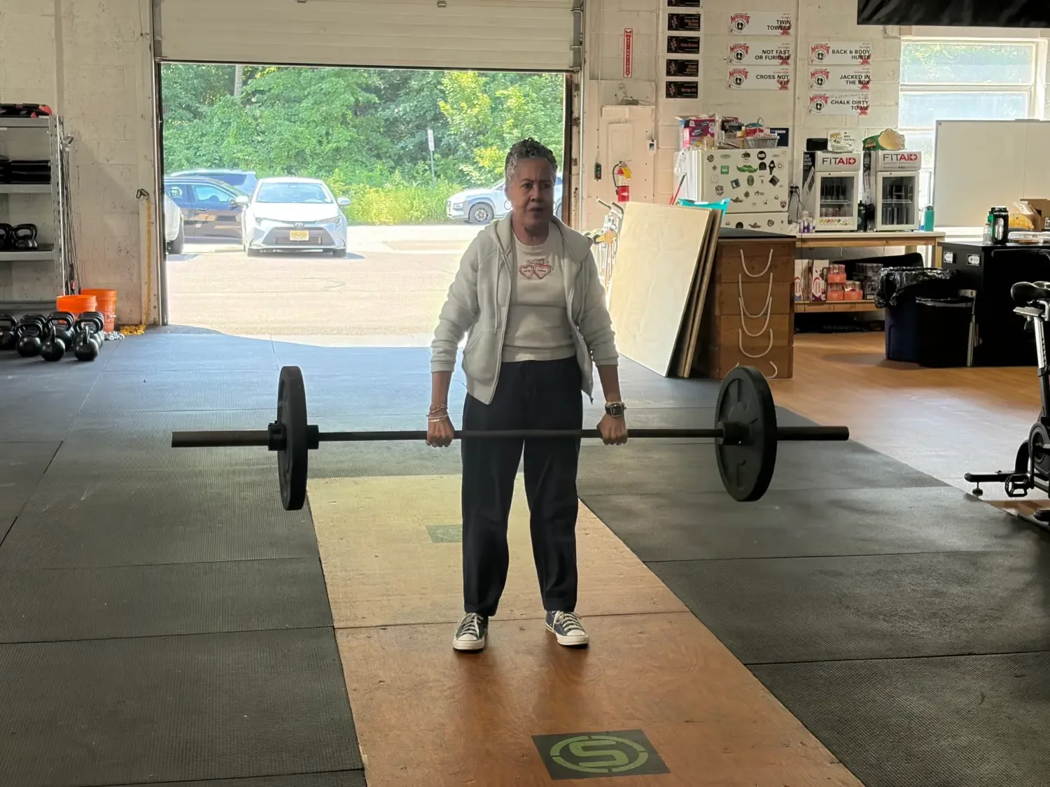 A Senior Fitness member lifting a barbell