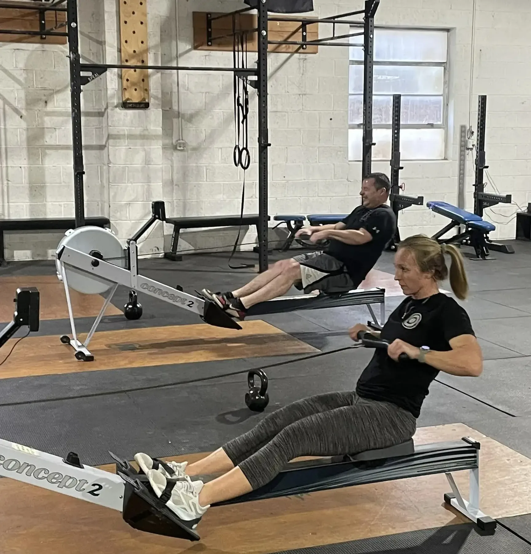 Members rowing side by side during a class