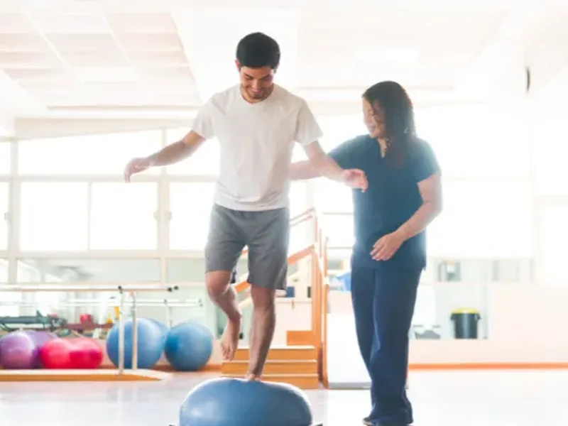 Physical therapist assessing a patient's balance and gait
