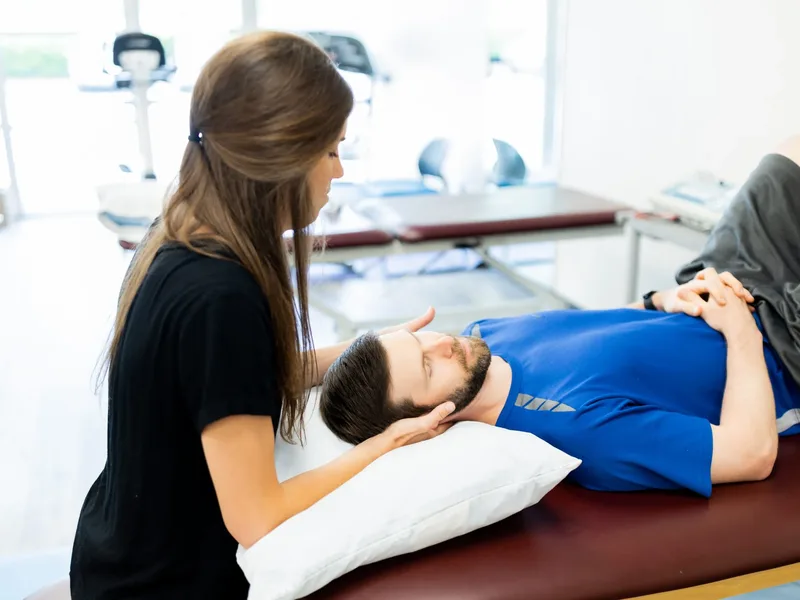 Physical therapist performing a vestibular and oculomotor assessment for concussion therapy